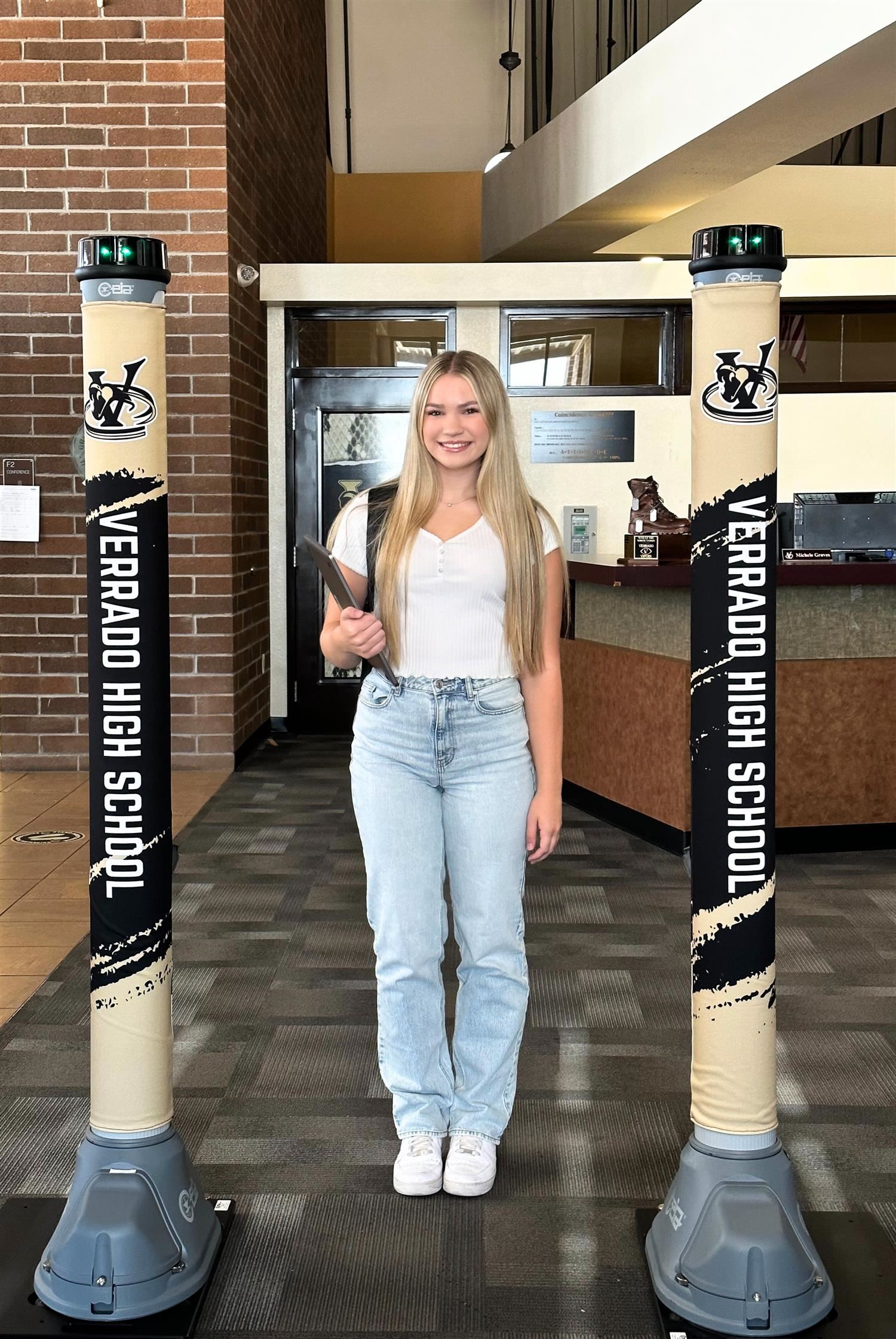 Teen girl smiling by the metal detectors